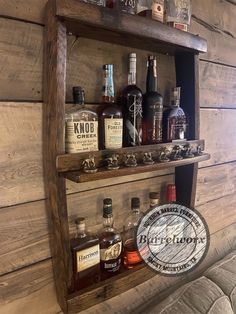 an old wooden shelf with liquor bottles on it