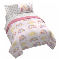 a bed with rainbows and clouds on it