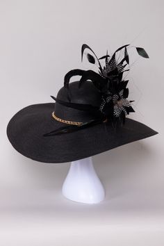 The Pure Elegance Derby Hat embodies timeless sophistication with its sleek design and luxurious materials. Adorned with subtle embellishments of feathers, flowers, and a beautiful gold chain, it adds a touch of glamour to any outfit. Versatile and refined, this hat is perfect for derby events, weddings, or garden parties, making a memorable statement with its understated charm and impeccable style. NO RETURNS/EXCHANGES due to the nature of the product (special occasions and headwear). Not all s Tea Hats, Neoprene Bag, Backpack Organization, Elegant Hats, Pure Elegance, Derby Hat, Garden Parties, The Pure, Derby Hats