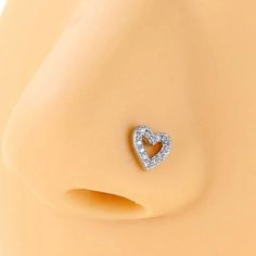 a heart shaped diamond earring on top of a mannequin