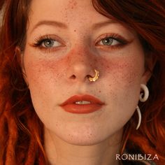 a woman with freckles on her face and nose