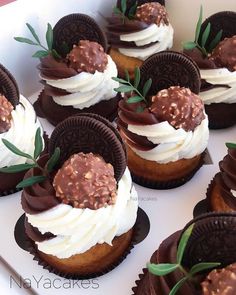 cupcakes decorated with oreo cookies and white frosting are in a box