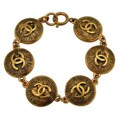 CHANEL vintage antiqued gold tone sunburst coin links bracelet featuring CC logos. Spring clasp closure. Embossed CHANEL Made in France on the reverse of each coin. Indicative measurements : length approx. 20 cm (7.87 inches) / coins diameter approx. 2.1 cm (0.83 inch). Material : Gold tone metal hardware. NOTES - This is a preloved vintage item, therefore it might have imperfections. - Colors may differ slightly from actual product appearance due to differences in lighting conditions. - As a bu Vintage Jewelry With Gold-tone Logo Plaque, Chanel Bracelet, The Crown Jewels, Chanel Vintage, Crown Jewels, Vintage Chanel, Metal Hardware, Gold Tone Metal, Made In