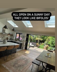 an open kitchen and dining room with the words, all open on sunny day they look like bifolds