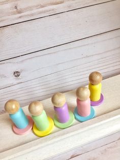 a group of wooden toys sitting on top of a shelf