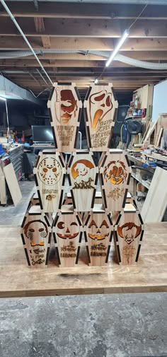 a group of carved wooden pieces sitting on top of a wood table in a garage