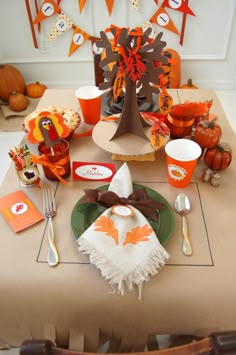 a thanksgiving table setting with turkey napkins