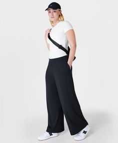 Our super comfortable trousers for luxe lounging. Soft, sustainable fabric made from plant-based modal Lenzing™ yarn. Effortless pull on design and a relaxed wide leg fit. Wear high rise or with the wide waistband folded down. 2 subtle slip pockets at the hips. Rise length for size S: 9" / 23cm. Inseam length: 29" / 73cm.. Model wears size S and is 178cm/5'10"tall. Style Code: SB8238Colour: Black Comfortable Trousers, Womens Black Pants, Sustainable Fabric, Teacher Outfits, Sweaty Betty, On Design, Sustainable Fabrics, Tailored Trousers, Wide Waistband