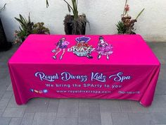 a pink table cloth with the words royal princess kids spa on it sitting in front of potted plants