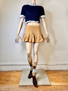 "I love this 90s pleated mini skirt. It looks so much like the Prada 2022 runway (see last pic). The skirt is a piquet textured tan skirt. It is fitted from the waist to the hip and then there are large pleats at the hip giving the skirt a lot of body. There is a side zip closure. The skirt is a mini skirt. It is in great condition. It is labeled a size 7/8. It is rayon and nylon but it has a cotton like look and feel. The sale is for the skirt only. The other items will be available in other li Fitted Flared Tennis Skirt For Fall, Cotton Mini Skirt With Pleated Hem, Fitted Pleated Skort For Fall, Brown Fitted Mini Pleated Skirt, Fall Pleated Flared Skort, Preppy Mini Pleated Skirt For Fall, Fitted Pleated Mini Skirt For Fall, Fall Pleated Tiered Mini Skirt, Fall Preppy Mini Pleated Skirt