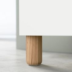 a wooden table lamp with a white shade on it's top and bottom part