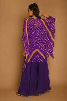 Purple kaftan tunic with all-over chevron print and embroidery at the neckline. Comes with palazzo.
Component: 2
Printed, Embroidered
Neckline: V-Neck
Sleeve Length: Three Quarter
Fabric: Georgette
Color: Purple
Embroidery at the neckline
Tie-up at the neckline with tassels - Aza Fashions Purple Kaftan, Top With Palazzo, Purple Embroidery, Kaftan Tunic, Printed Kaftan, Kaftan Top, Palazzo Set, Embroidered Neckline, Chevron Print