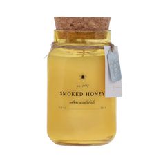 a jar of smoked honey with a tag on the lid and label attached to it