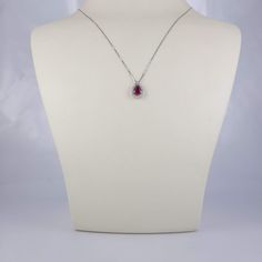 "White gold 14k necklace set with a pear shaped natural ruby 6×4 mm, 0.45 carat, surrounded by 16 halo round diamonds of 0.14 carat weight VS-G grade. Including a box chain 18\" Long. The ruby and diamonds are 100% natural of a very high quality, the diamonds are full of sparkle. The pear shape ruby weights 0.45 carat is full of rich color, surrounded by a halo of 16 diamonds of 0.14 carat VS-G Gold: 14k 1.90 gram (approx.) Chain: 16\"/18\"/20\" long Ruby: 0.45 carat, 6x4 mm, the ruby is natural Fine Jewelry Ruby Diamond Necklace Brilliant Cut, White Gold Ruby Necklace With Diamond Cut, Pear-shaped Diamond Birthstone Necklace, White Gold Teardrop Pendant Necklace With Gemstone, White Gold Ruby Necklaces With Brilliant Cut, White Gold Ruby Necklace With Brilliant Cut, Fine Jewelry Ruby Teardrop, Ruby Teardrop Fine Jewelry, Formal Ruby Necklace With Halo Setting