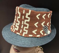 A classy brown and black Mudcloth  and straw hat combination. It has  hand painted bold african art designs . This can be made to fit . It is a unisex hat that both men and women will enjoy. The hat has endless possibilities .  For more selections visit the hat and scarf section at evelyncreationinc@etsy.com. Don't delay order yours today. Brown Woven Fedora Straw Hat, Adjustable Brown Woven Fedora, Brown Woven Fedora With Short Brim, Brown Woven Fedora Panama Hat, Brown Woven Brimmed Panama Hat, Brown Woven Hat With Short Brim, Brown Brimmed Straw Hat, Brown Woven Brimmed Fedora, Brown Woven Fedora With Curved Brim