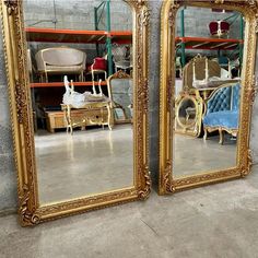 two large mirrors sitting next to each other on the floor in front of a wall