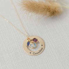 A beautiful golden gift for your Grandma or Mom. What better way to remind her of her family - a necklace personalized with names and birthstones representing each grandchild Product details MATERIAL: 14K Gold Pendant, Plated or Gold Filled ChainSIZE: 1 1/8" (28.575) pendantCHAIN LENGHT: 16", 18", 20" based on selectionCHAIN STYLE: cable, curb, rolo, double ropeBIRTHSTONES: Optional based on selectionENGRAVING: Up to 5 characters (including spaces) around the circumference of the washer Engraved Personalized 14k Gold Birthstone Necklace, 14k Gold Personalized Birthstone Necklace, Personalized May Birthstone Necklace In Yellow Gold, Personalized Engraved Gold Birthstone Necklace, Gold Engraved Birthstone Necklace For Personalized Gift, Personalized Yellow Gold May Birthstone Necklace, 14k Gold Nameplate Necklace With Birthstone, Mother's Day Nameplate Birthstone Necklace, Mother's Day 14k Gold Birthstone Charm Necklace