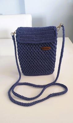 a blue purse sitting on top of a white table