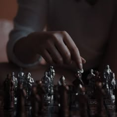 a person is playing chess on a table