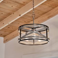 a chandelier hanging from a wooden ceiling