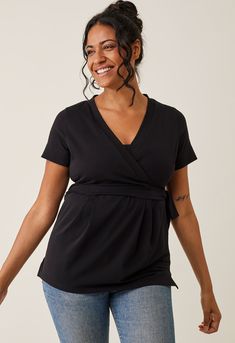 A soft and stretchy wrap top, thoughtfully designed to flatter your growing belly while discreetly offering effortless nursing access. The wide cuff on the sleeves can be worn up or down for added versatility. With an elastic band at the back, it accentuates your waistline, creating a flattering silhouette. This is the perfect, versatile everyday essential for moms at all stages!


Soft and stretchy cotton jersey
Sustainable material: 92% organic cotton and 8% elastane
Made in Portugal by Erius Fitted Solid Top With Surplice Neckline, V-neck Faux Wrap Top For Layering, Fitted Solid Color Wrap Top, Versatile Wrap Top For Layering, Versatile Black Wrap Top, Black Versatile Wrap Top, Black Stretch Nursing-friendly Top, Fitted Maternity Tops Bump Friendly, Fitted Bump Friendly Maternity Tops