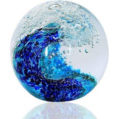 a blue and white glass ball with water on it