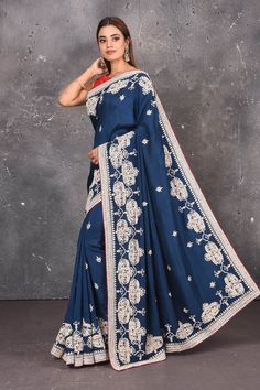 Look elegant adorning this navy blue color art silk saree beautified with gota patti and thread work embroidered floral designs all over along with its distinctive heavily detailed border and pallu. A scalloped border is given a grand look with a beautiful floral setting blossoming with colourful threadwork of flowers, gota patti leaves and dazzling cut dana and mirror work details. Mirror bootis are scattered all over the saree to match the brightness of the happy look. DISCLAIMER:- The shown s Scalloped Border, Embroidered Saree, Fashion Journals, Designer Sarees Online, Art Silk Sarees, Traditional Fabric, Blue Soft, Color Art, Mirror Work