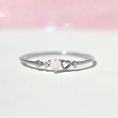 Our love is a forever type of thing! This ring features two petite hearts. It's feminine and simple and the perfect stacking ring. 18k gold plated, 18k rose gold plated, or rhodium plated over brass with a protective coating Cubic zirconia stones Available in sizes 5-8 Approx 3mm width Shop our entire Rings Collection here Promise Rings Cheap, Cute Promise Rings Silver, Small Heart Ring, Simple Promise Rings Silver, Simple Promise Rings For Her Silver, Dainty Promise Rings Silver, Small Rings Simple, Small Promise Rings, Promise Rings Simple Silver