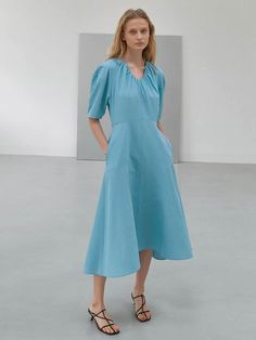 Editor's NotesThis dress is made of polyester. It features a volume sleeve and A-line detail which makes the dress more feminine and romantic. The natural flare creates a feminine and stylish mood. - Classic design long-length dress- Curved neckline detail - Dropped shoulder and lightweight - Shirring detail on the neckline Measurements(in.) Size: Size (55/66) - Total Length: 46.45 in. / 46.85 in.- Chest: 36.22 in. / 37.80 in.- Waist: 28.74 in. / 30.31 in.- Sleeve: 21.65 in. / 22.04 in. *Model info: Height 5' 80, Bust 30.70, Waist 22.83, Hip 35.03, Wearing a size 55 or Free size                    Height 5' 67, Bust 30.70, Waist 21.25, Hip 34.25, Wearing a size 55 or Free size Spring Voluminous A-line Dress, Feminine A-line Midi Dress With Pleated Sleeves, Chic A-line Dress With Gathered Sleeves, Elegant Voluminous Puff Sleeve Dress For Spring, Evening A-line Puff Sleeve Dress For Spring, Elegant Voluminous Puff Sleeve A-line Dress, Elegant A-line Puff Sleeve Dress, Spring Puff Sleeve Dress With Draped Balloon Sleeves, A-line Dress With Pleated Sleeves