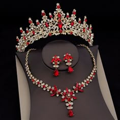 a red and white tiara with matching earrings