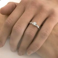 a woman's hand with a diamond ring on it