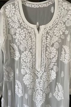 Feel the beauty and uniqueness of our White Hand Embroidered Chikankari Kurta. Admire the scattered motifs on the front, back and sleeves. Viscose 46" length Long sleeves 18" Side slits Chikankari embroidery Hand embroidered Dry clean Fit: True to sizeInside Margin: No Chickenkari Embroidery Motifs, White Lucknowi Kurta, Chickenkari Suits, Lucknowi Chikankari Suits, White Chikankari Kurta, Phulkari Pants, Lucknowi Kurta, Indian Kurtis, Patiala Salwar Suits