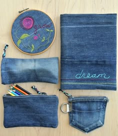 a denim bag with pencils, scissors and an embroidered name on the front pocket