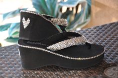 "These Swarovski Crystal Platform Flip Flops have extra bling added. She customized the diamond divas to give them more Sparkle and Shine. These are amazing and so much more!! This just goes to show you what you can customize. We use only the best high fashion wedge flip flops available. Platforms have a Soft synthetic strap with a squishy EVA top-sole that has anatomical arch support. Ethyl Vinyl Acetate or E.V.A. is one of the best shock absorption materials available today. This is the reason Pretty Flip Flops, Dressy Flip Flops, High Heel Thong Sandals, Fin Fun Mermaid, Bling Flip Flops, Bling Heels, Wedding Flip Flops, Skull Shoes, Heeled Flip Flops