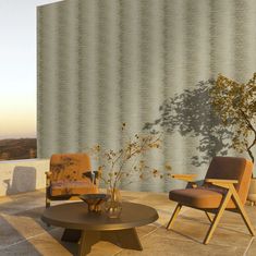 two chairs and a coffee table in front of a wall with a shadow on it