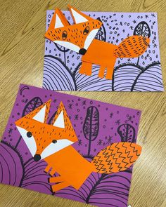 two pieces of paper cut out to look like foxes on purple and orange background with stars