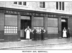 an old black and white photo of three men standing in front of a store