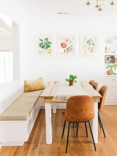 a dining room with white walls and wooden floors