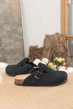 Exude casual-cool style in comfort in these slip-on-and-go clogs, crafted from a soft suede in a versatile neutral hue for effortless pairing. A durable TPU sole ensures tread-safe steps. Suede upper Man-made leather lining Man-made insole TPU sole Casual Slip-on Slippers With Buckle Closure, Black Slip-on Clogs With Textured Footbed, Casual Black Mules With Leather Footbed, Casual Black Slip-on Mules, Casual Suede Clogs With Textured Footbed, Casual Closed Toe Clogs With Buckle Closure, Casual Black Mules With Buckle Closure, Comfortable Black Suede Sandals, Black Textured Footbed Slip-on Clogs