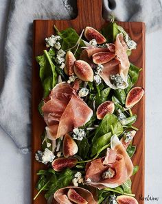 figs and prosciutto salad on a wooden cutting board