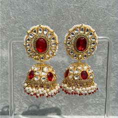 Handmade Style: Traditional Kundan Jhumka Earrings Material: 18k Yellow Gold Plated, Lab Simulated Ruby Stones, Kundan Stones, Pearls Imported Item Number: 7073R 22k Gold Meenakari Earrings For Navratri, Ruby Meenakari Jhumkas For Festivals, 22k Gold Chandbali Bridal Earrings With Latkans, Bollywood Style Yellow Gold Earrings With Latkans, Bollywood Style Ruby Chandbali Jhumkas, Red Jhumkas For Ceremonial Use During Diwali, Traditional Ruby Jhumkas With Tilla, Heavy Ruby Jhumkas For Festive Occasions, Bollywood Style Ruby Jhumkas With Intricate Design