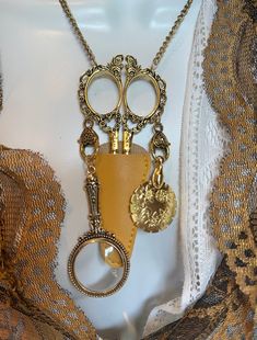 a necklace with two keys attached to it on a mannequin headdress