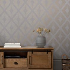 a living room with an entertainment center and wall papered in grey geometric designs on the walls