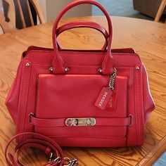 Coach Handbag In Immaculate Condition! Beautiful Red Color With Front Pocket And Detachable Shoulder Strap. Inside Has 3 Compartments With A Center Zip. Fabulous Addition To Your Collection. Will Add In Half Full Bottles Of Coach Cleaner And Moisturizer. 13.5 Inches Wide At Base. Red Coach Shoulder Bag For Office, Red Crossbody Bag With Silver-tone Hardware, Red Bag With Silver-tone Hardware For Daily Use, Red Satchel With Silver-tone Hardware For Daily Use, Daily Red Bag With Silver-tone Hardware, Coach Red Satchel With Detachable Handle, Coach Red Satchel With Detachable Strap, Red Rectangular Satchel With Silver-tone Hardware, Red Satchel Bag With Silver-tone Hardware