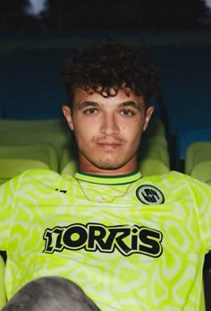 a young man sitting in a stadium wearing a green jersey with the words yorks on it