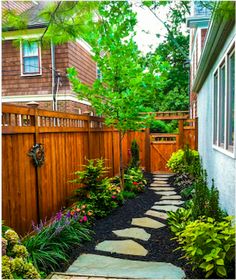 a wooden fence and some flowers in the yard