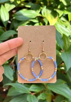 Size Drop Length 2.36 in Small circle 0.47 in Diameter of the loop 1.53 in Bright Periwinkle Blue Dangle Hoop Earrings  This delicate memory wire hoop earring is modestly sized and exudes elegance. It features a classy blend of bright periwinkle blue and golden beads meticulously strung together, forming a captivating design. The beads are skillfully looped around the wire, creating a charming and girly accessory. To ensure both strength and extra dangle, the design is completed with a small golden circle to which the beads are securely hooked. The bright periwinkle color not only adds a pop of vibrancy but also symbolizes a sense of beauty and versatility, making it a perfect choice for various occasions. Pageant Earrings, Wire Hoop Earrings, Prom Earrings, Blue Crystal Earrings, Dangle Hoop Earrings, Teardrop Dangle Earrings, Periwinkle Blue, Gold Gift, Girly Accessories