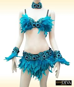 a mannequin dressed in blue feathers and beads