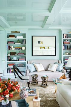 a living room filled with furniture and bookshelves