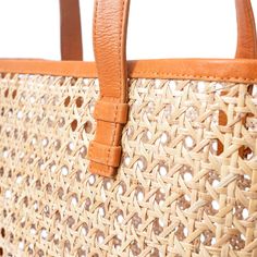 The Ideal basket tote bag. Handcrafted using our cane rattan with premium genuine leather. The perfect light, easy to pack for your travel adventures carry all beach day, market run, summer lunch date shoulder tote bag. (PRODUCT INFO): Material: Genuine Cow leather + Cane RattanLining: Unlined interiorSize: 14" W x 11" H x 4.3" DOpen top no closure (SHIPPING INFO): All our items are made-to-order, therefore please allow 3-5 business days for production. Our goal is to become more sustainable thr Rectangular Tan Straw Bag With Leather Handles, Travel Woven Leather Tote Bucket Bag, Travel Tote Bucket Bag In Woven Leather, Tan Woven Leather Bag For Everyday Use, Leather Shoulder Bag With Bamboo Handle For Vacation, Tan Woven Leather Travel Bag, Leather Bucket Bag With Bamboo Handle In Natural Color, Travel Woven Leather Shoulder Bag In Natural Color, Natural Leather Bucket Bag With Bamboo Handle